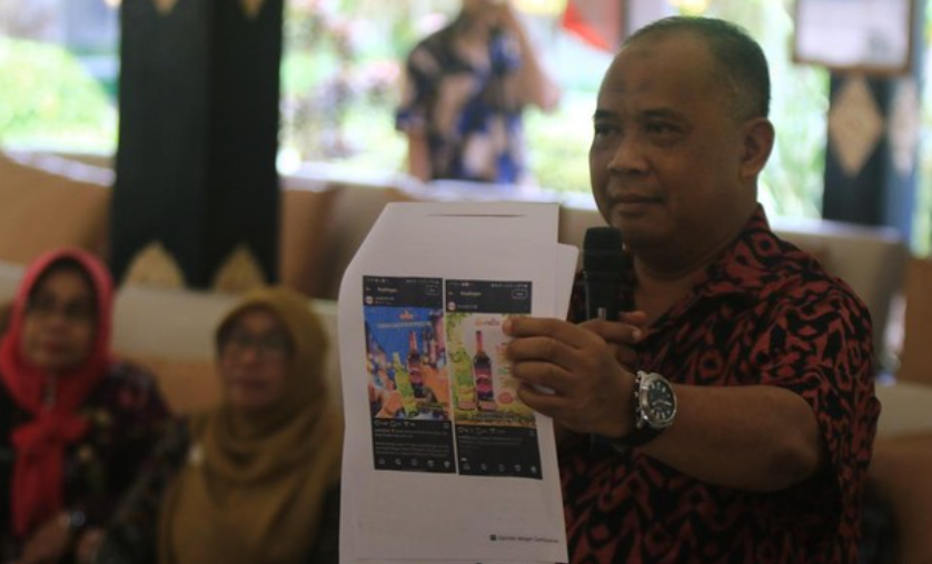 Bupati Sleman Harda Kiswaya menunjukkan iklan minuman beralkohol Anggur Merah 'Kaliurang' di Pemkab Sleman, Senin (21/4/2025)